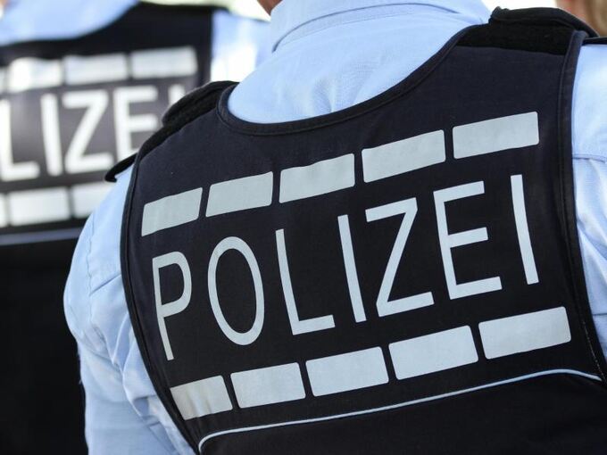 Ein Polizist trägt eine Weste mit der Aufschrift «Polizei»