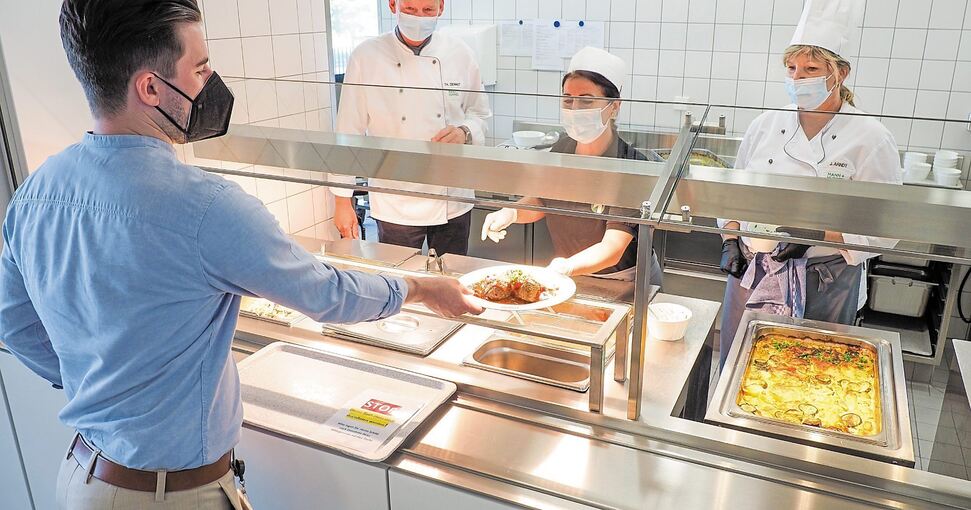 Mann+Hummel-Mitarbeiter Philipp Tombar bekommt in der Kantine des Ludwigsburger Unternehmens Fleischbällchen in spanischer Soße mit Gemüsereis gereicht. Das Essen geben Lucia Capparelli (links) und Jutta Arndt aus. Hinter der Ausgabe ganz links steht