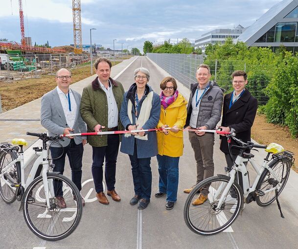 Die Strecke führt zwischen den Gebäuden von Hahn + Kolb (rechts) und dem Rohbau für Firma Goetze hindurch. Eröffnet haben sie (von links): Matthias Knobloch (Fachbereich Mobilität), OB Matthias Knecht, Staatssekretärin Elke Zimmer, Landtagsabgeordnet