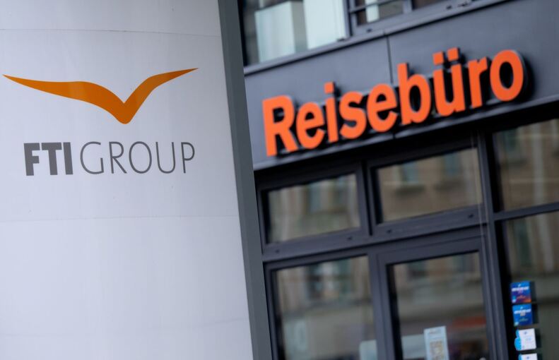 Das Logo des Reiseveranstalter FTI  vor einem Reisebüro