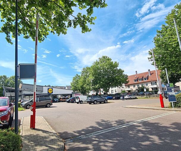 Der Discounter Lidl in der Hindenburgstraße: Ein Schild (rechts) weist am Eingang und über den Parkplatz verteilt auf die „automatische Zeitmessung mit Kennzeichenerkennung“ hin. Die Kamera sitzt auf einem Pfosten vor dem Baum in der Mitte, bei der E