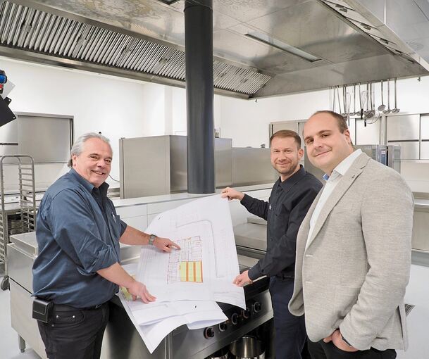Architekt Hans-Peter Vogel (links) bespricht mit den Freetime-Chefs Marcel Leuze (rechts) und Thomas Urlauber in der Winkelwerk-Küche in Benningen anhand der Pläne die Vergrößerung der Küchenflächen.
