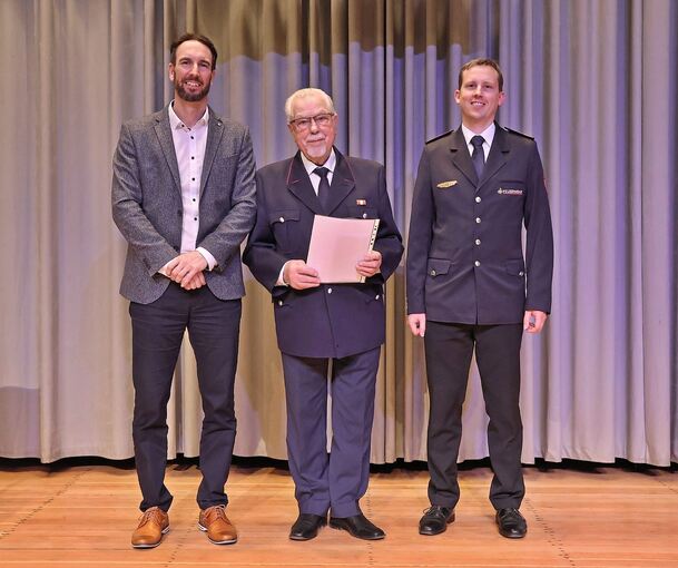 Bürgermeister Alexander Noak und Kommandant Fabian Kunberger (rechts) ehren Martin Held für 70 Jahre Feuerwehrdienst.