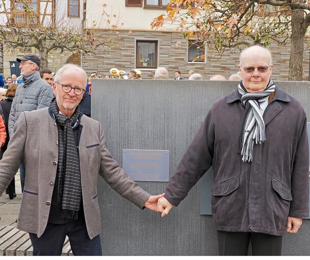 Jean-Marc Cosson (rechts), der Vorsitzende des französischen Partnerschaftskomitees, und Bernhard Haudeck, sein Schwieberdinger Pendant, vor der Gedenktafel für Wolfgang Sippel.