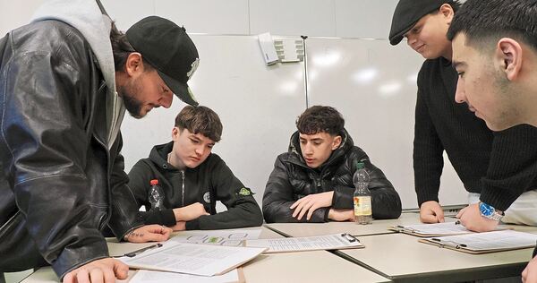 Rapper Morpheuz (links) tüftelt mit Schülern an Texten für einen Schulsong.