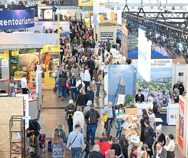 Besucher gehen am ersten Tag der Tourismusmesse Caravan, Motor und Touristik durch eine Messehalle mit Ausstellern von Ferienregionen.