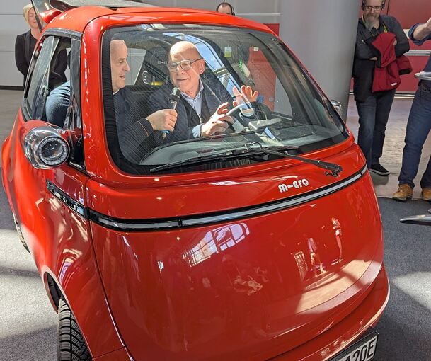 Landesverkehrsminister Winfried Hermann im Microlino (r).