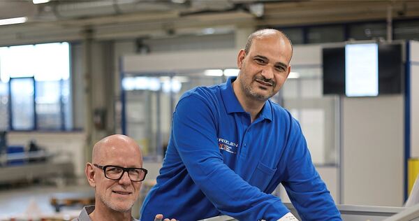 In einer Frizlen-Werkshalle: Michael Westreicher (links) und Tareq Alhallak an einem Widerstand mit Schaltschrank.
