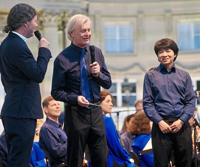 Intendant Lucas Reuter (links) spricht mit Dirigent Jan Caeyers (Mitte) und Pianist Kit Armstrong.