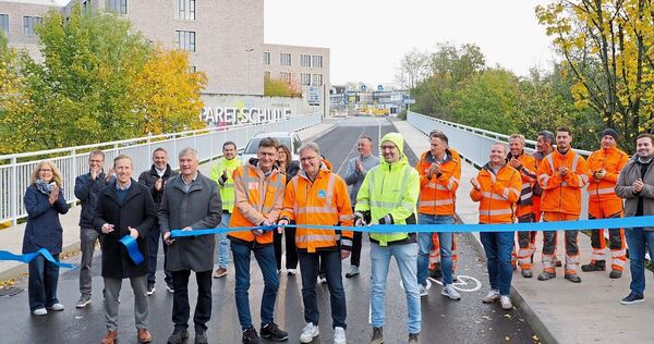 Das Band ist durchschnitten und die Brücke wieder für den Verkehr freigegeben. Auch Bürgermeister Jan Hambach (vorne links) greift zur Schere.